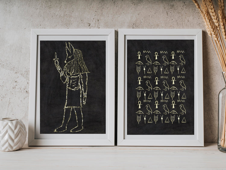 Ancient Egyptian wall art, set of two, black and gold, Anubis, art print displayed in frames.
